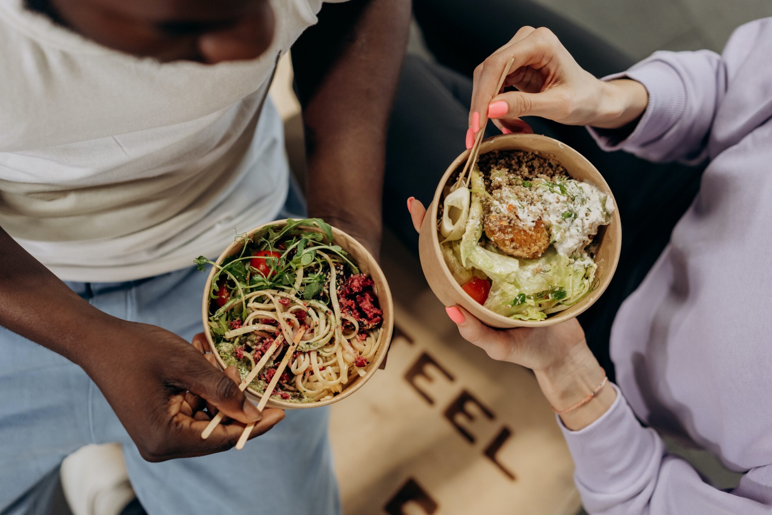 Two Women Eating a nutritious bowl of noodles and salad