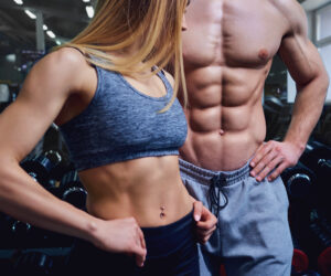 Strong man and a woman are posing with beautiful bodies.
